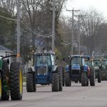 Tractors rumble down Main Street in Auburndale, Friday, May 1, 2015.