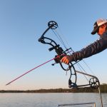 Allan Brusky, an avid bowfisherman, demonstrates firing into the water at Petenwell Lake in Rome, Wisconsin, May 18, 2016. The bow releases a special arrow that is attached to a taut string, which allows the archer to fire and then reel in the fish.