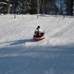 vil-woman-snow-tubing-down-hill